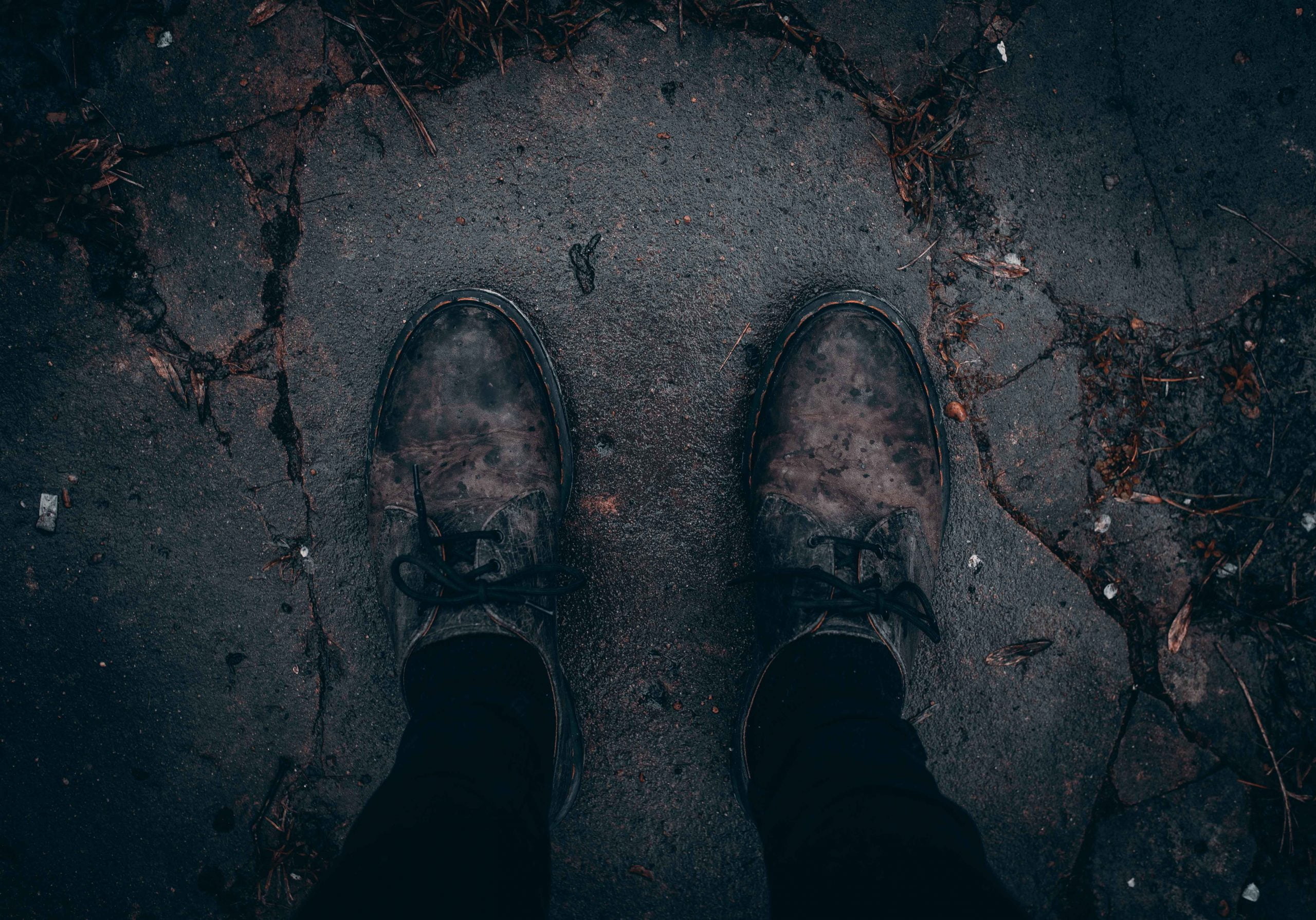 person taking photo of pair of brown shoes